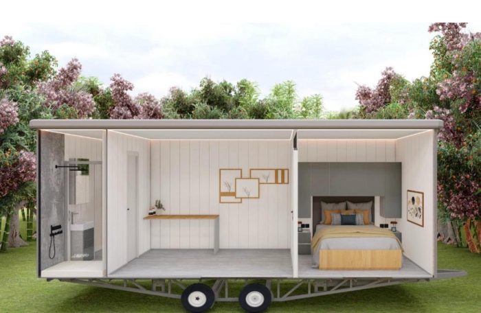 Estructura abierta de la unidad móvil Casa móvil con dormitorio y área de trabajo, rodeada de vegetación.